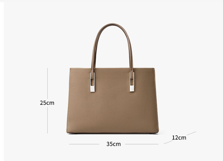 Woman carrying stylish genuine leather tote bag